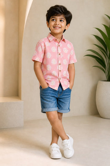 Boy wearing Basic Tribe Barfi peach leaf-print cotton shirt with denim shorts