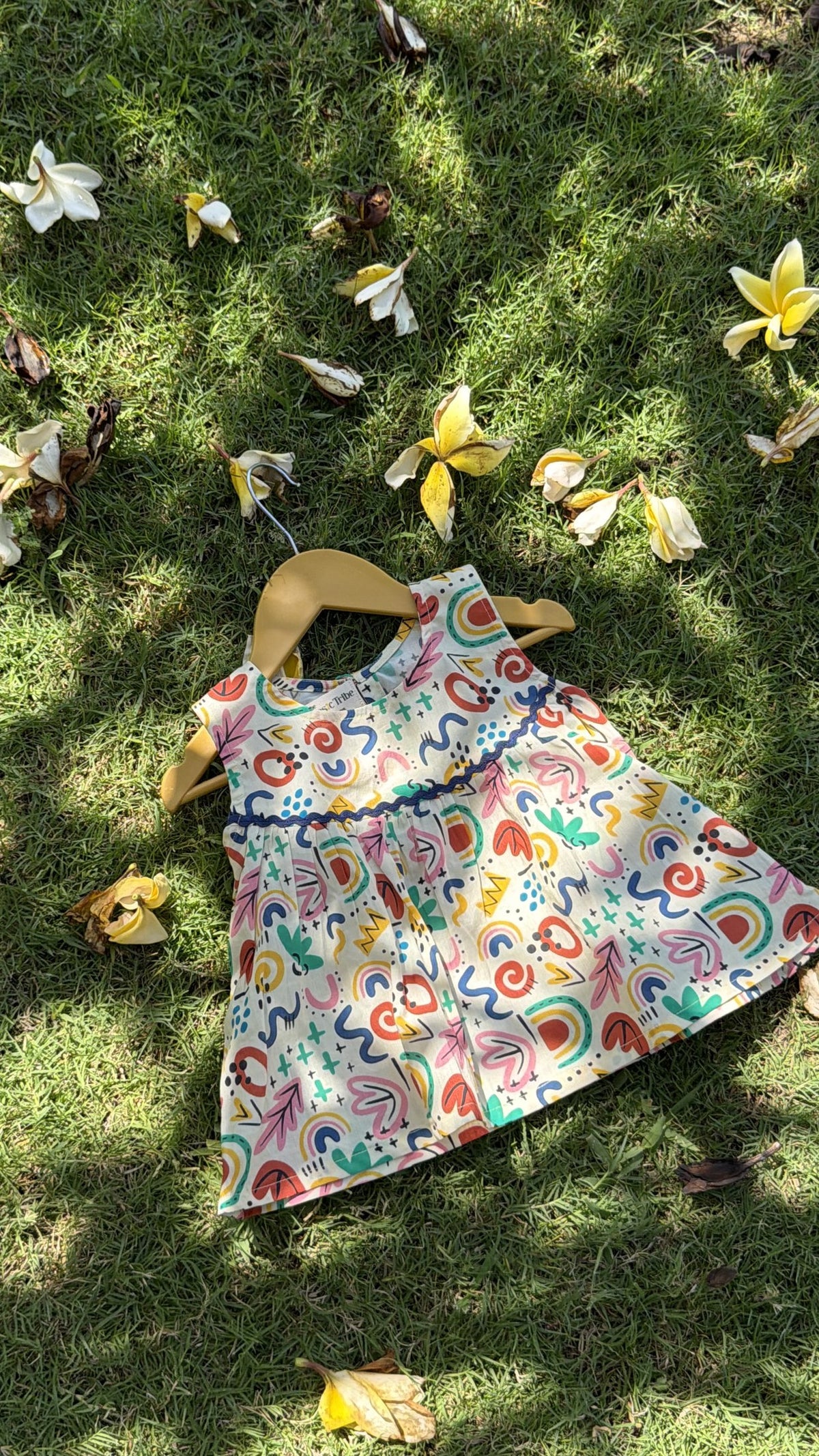 Flat lay of Basic Tribe Masakkali cotton top showing colourful abstract print and sleeveless shape