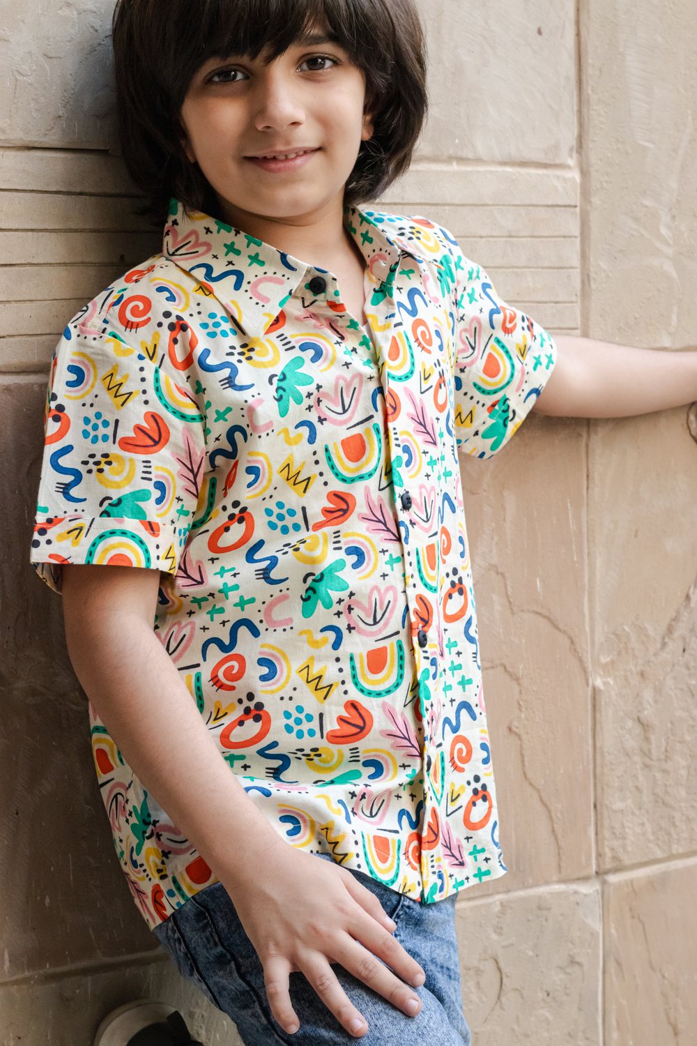 Close-up of child in Basic Tribe Soul Surfer abstract-print shirt showing collar and front