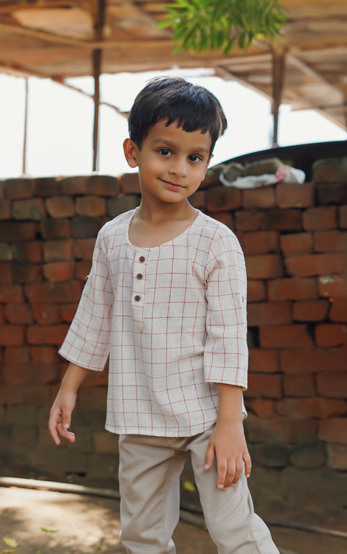 Boy wearing Basic Tribe Baby of the World checked kala cotton kurta top with front buttons