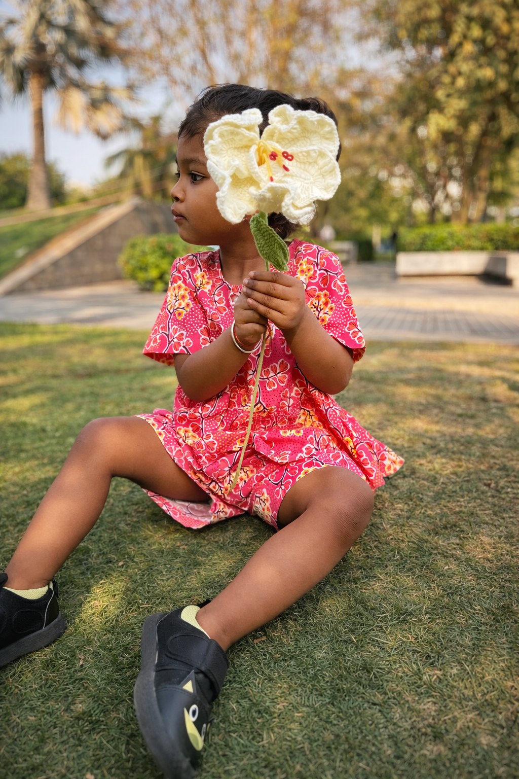 Girl holding a white flower in Basic Tribe Jhilmil coordinated pink cotton outfit