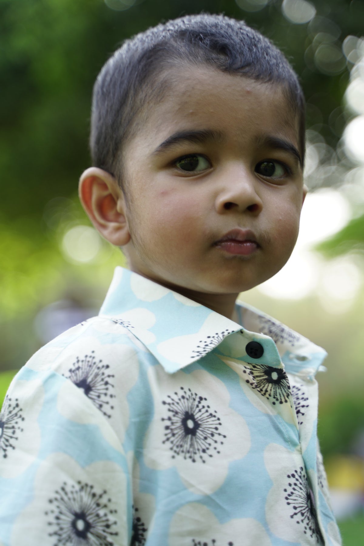 Close-up of Basic Tribe Farhan shirt showing blue floral print, collar and buttons