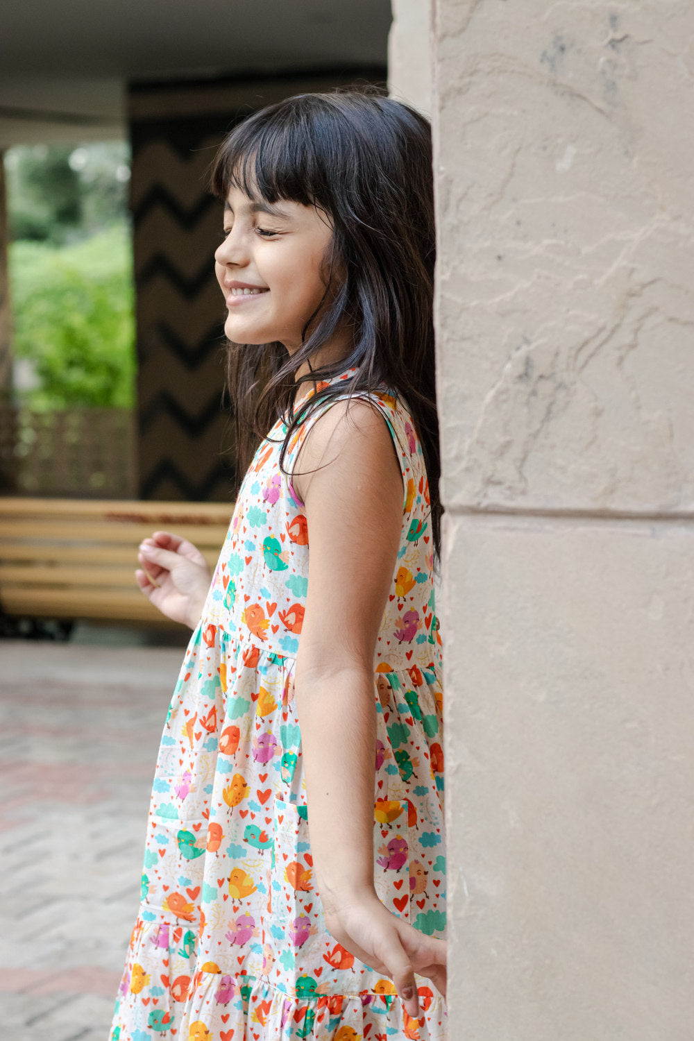 Side profile of Basic Tribe Twitter sleeveless girls dress with colourful print